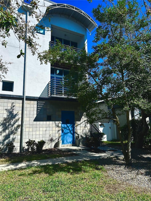 back of house with a balcony