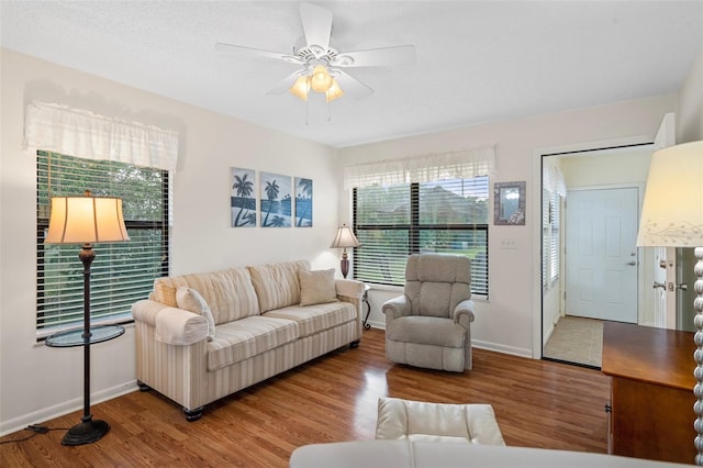 living room featuring hardwood / wood-style floors and ceiling fan