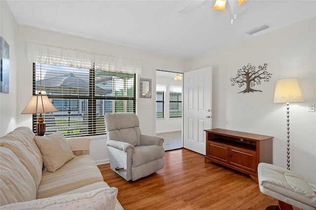 living room featuring hardwood / wood-style flooring and ceiling fan