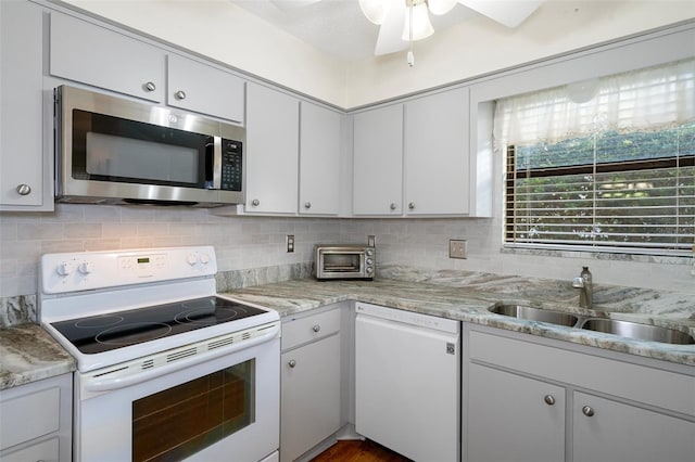 kitchen featuring white cabinetry, sink, tasteful backsplash, ceiling fan, and white appliances