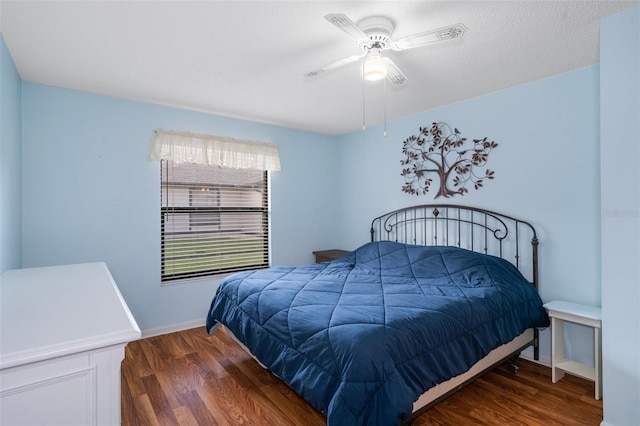 bedroom featuring a textured ceiling, dark hardwood / wood-style flooring, and ceiling fan