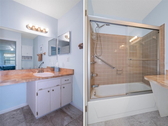 bathroom with shower / bath combination with glass door, a textured ceiling, and vanity