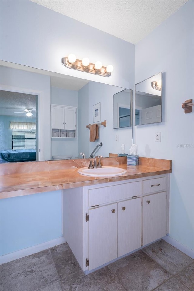 bathroom featuring vanity, a textured ceiling, and tile patterned floors