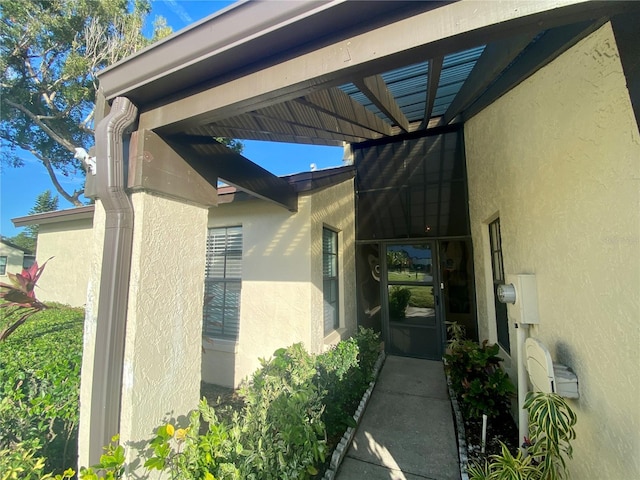 doorway to property featuring a carport