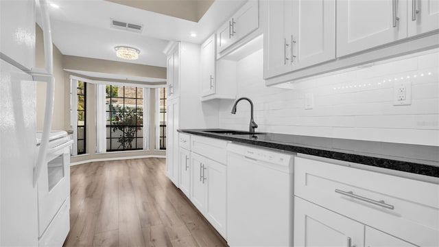 kitchen featuring sink, light wood-type flooring, white appliances, decorative backsplash, and white cabinets