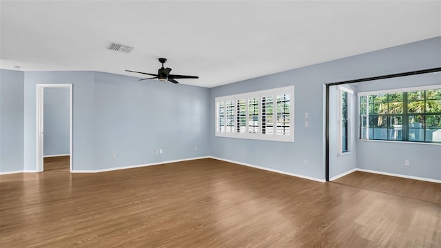 spare room with hardwood / wood-style floors and ceiling fan