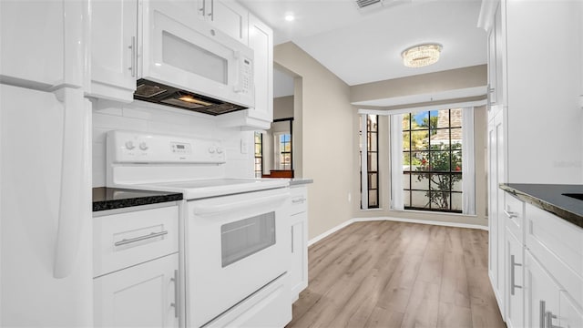 kitchen featuring tasteful backsplash, white cabinetry, dark stone counters, white appliances, and light hardwood / wood-style flooring