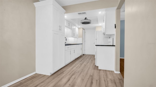 hall with sink and light hardwood / wood-style flooring