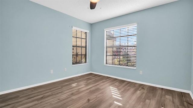 unfurnished room with hardwood / wood-style flooring and ceiling fan