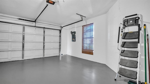 garage featuring a garage door opener and electric panel