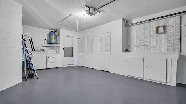 garage with a garage door opener, washer and clothes dryer, and secured water heater