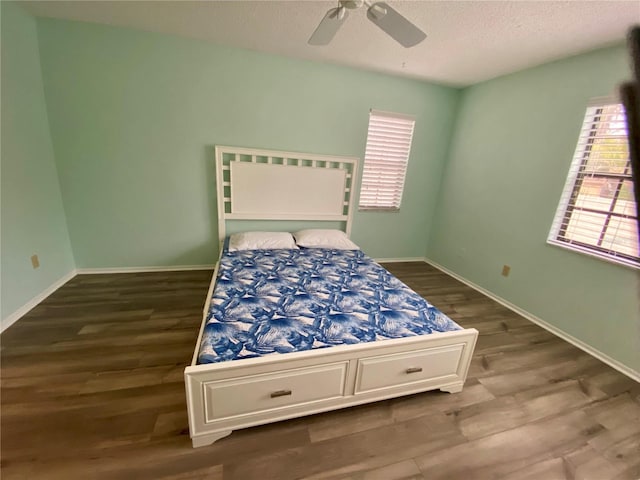 bedroom with hardwood / wood-style flooring, a textured ceiling, and ceiling fan