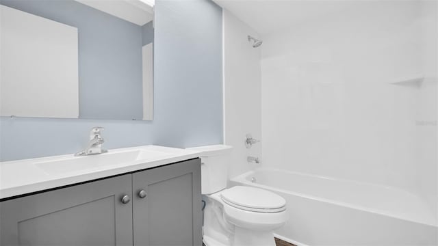 full bathroom featuring toilet, vanity, and bathtub / shower combination