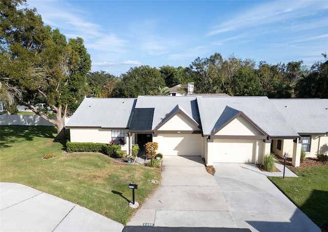 3499 Cedar Ln, Palm Harbor, FL 34684 - ranch-style home with driveway, a front yard, a garage, and stucco siding