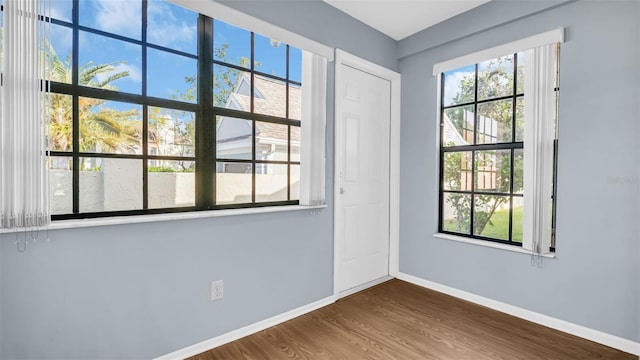 3499 Cedar Ln, Palm Harbor, FL 34684 - spare room featuring baseboards and wood finished floors