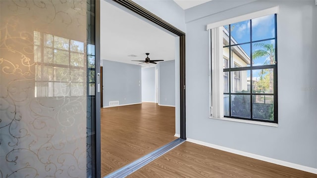 3499 Cedar Ln, Palm Harbor, FL 34684 - spare room featuring wood finished floors, baseboards, and a ceiling fan