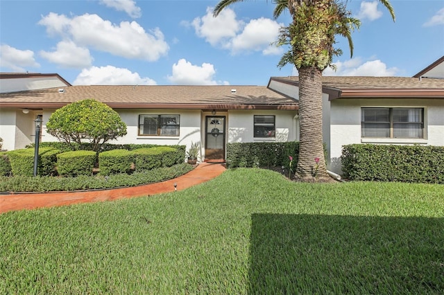 ranch-style house featuring a front lawn