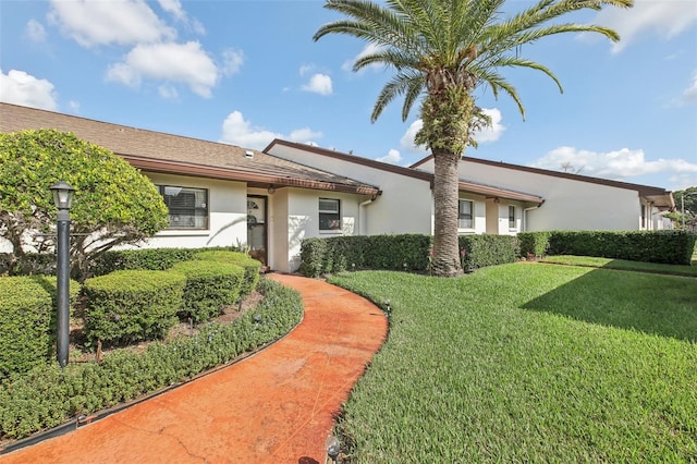 ranch-style home featuring a front yard