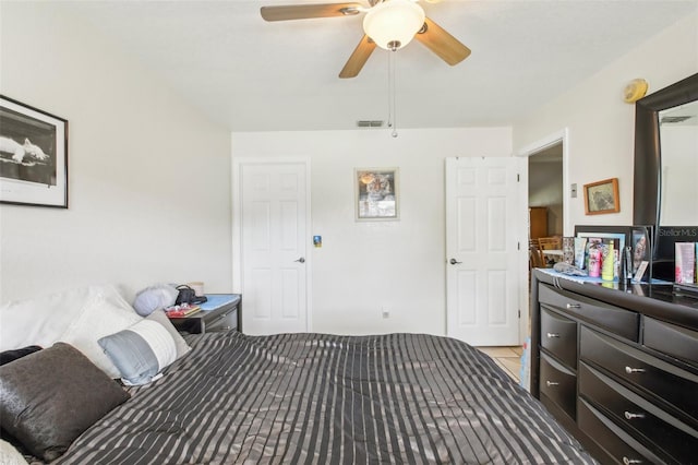 tiled bedroom with ceiling fan