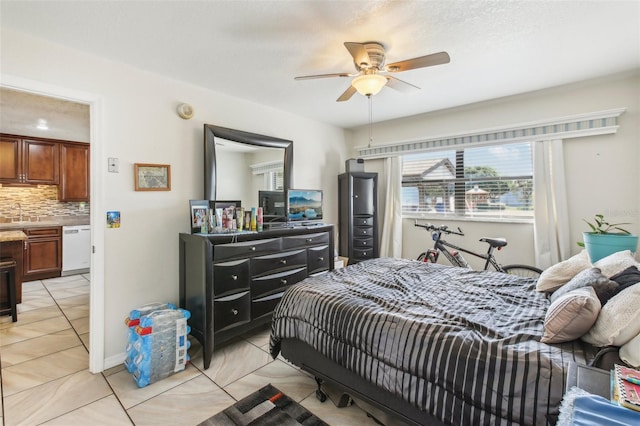 bedroom featuring ceiling fan, light tile patterned floors, and sink