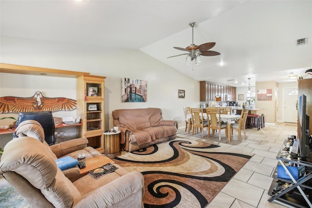 tiled living room featuring ceiling fan and lofted ceiling