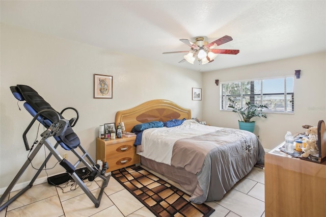 tiled bedroom featuring ceiling fan