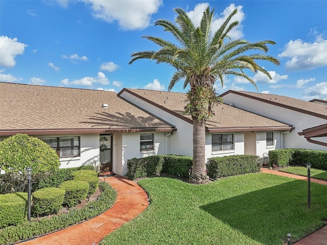 ranch-style house featuring a front lawn