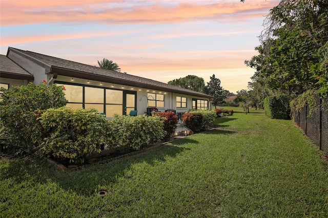 view of yard at dusk