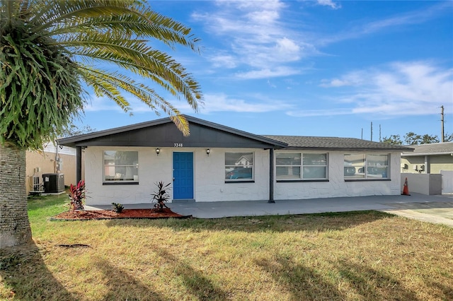 ranch-style home with a front yard and central AC