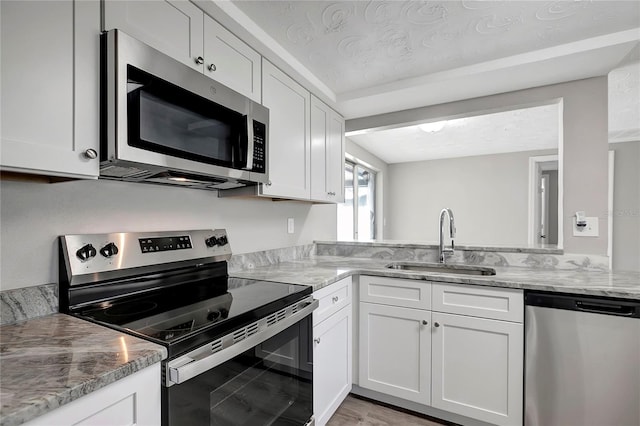 kitchen featuring white cabinets and appliances with stainless steel finishes