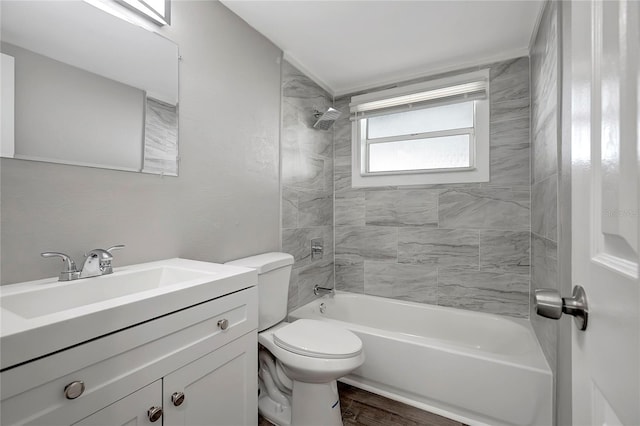 full bathroom with vanity, wood-type flooring, tiled shower / bath, and toilet