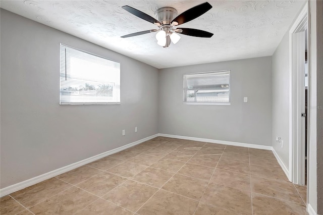 unfurnished room featuring ceiling fan and light tile patterned floors