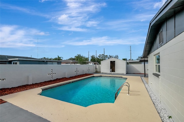 view of swimming pool with a shed and a patio