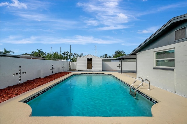 view of pool with a shed and a patio