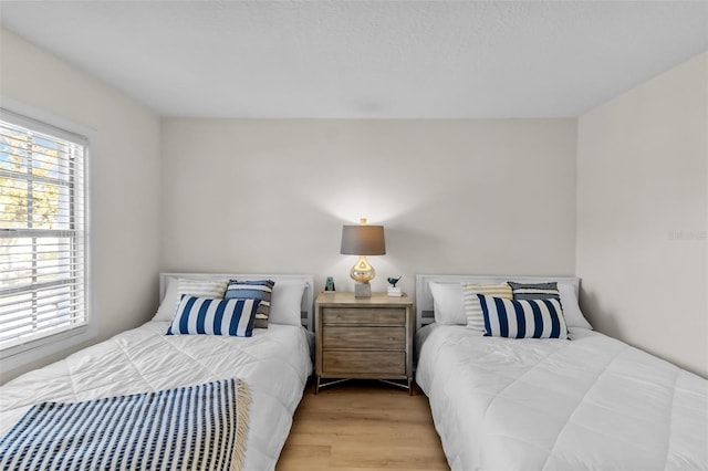 bedroom with light hardwood / wood-style flooring