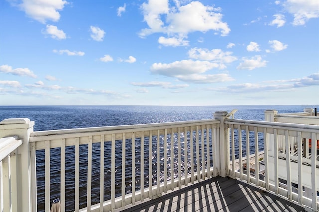 deck featuring a beach view and a water view