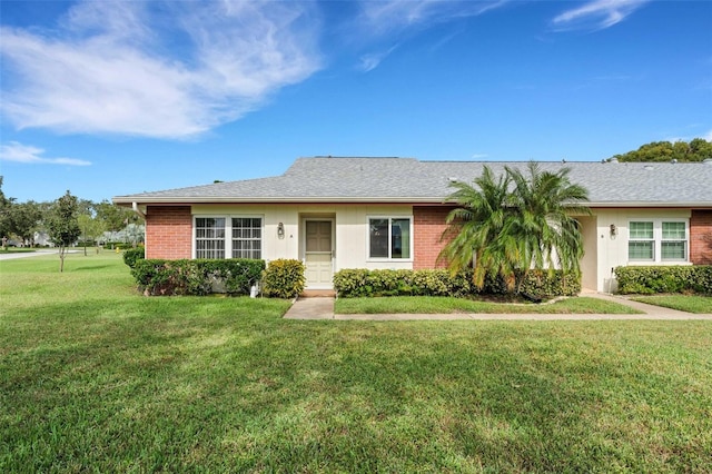 ranch-style home featuring a front lawn