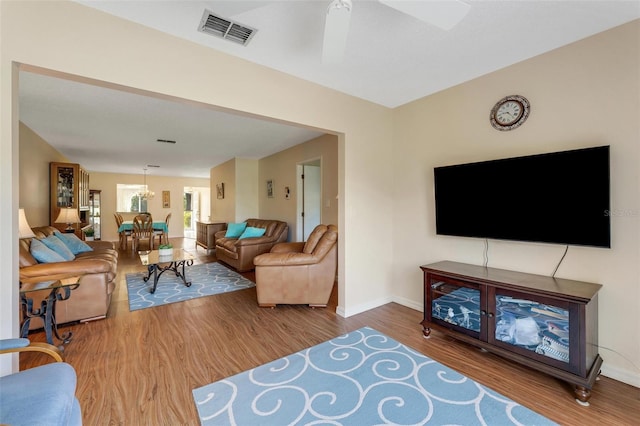 living room featuring ceiling fan and wood-type flooring