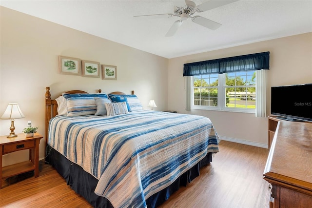 bedroom with hardwood / wood-style flooring and ceiling fan