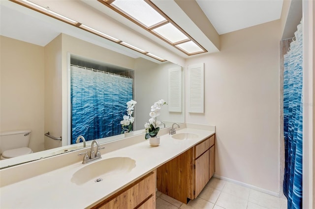 bathroom featuring tile patterned flooring, vanity, and toilet