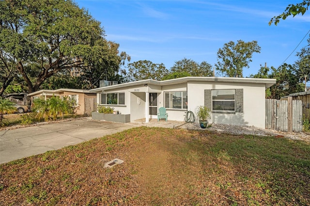 ranch-style home with a front lawn