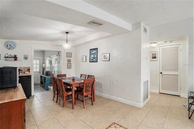 dining room featuring an inviting chandelier and light tile patterned floors