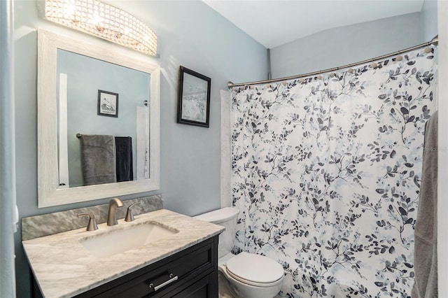 bathroom featuring a shower with curtain, vanity, and toilet