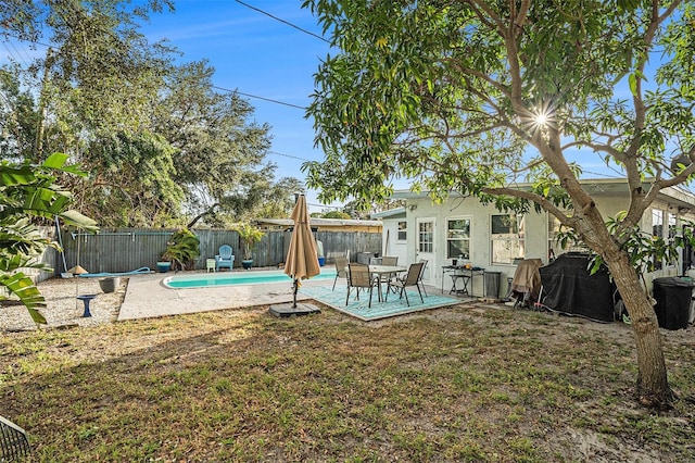 view of swimming pool featuring a lawn and a patio area