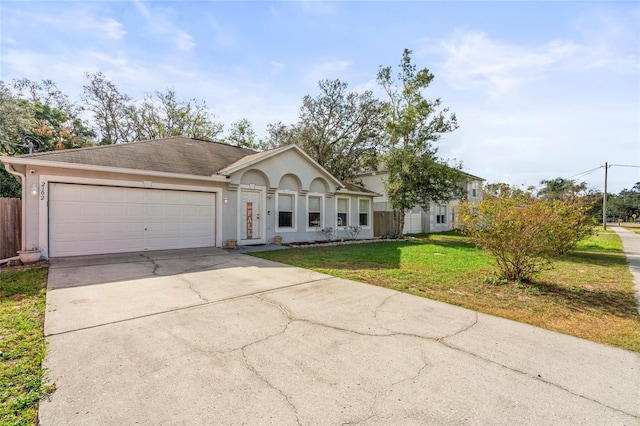 single story home with a garage and a front lawn