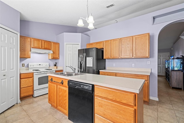 kitchen featuring sink, lofted ceiling, decorative light fixtures, a kitchen island with sink, and black appliances