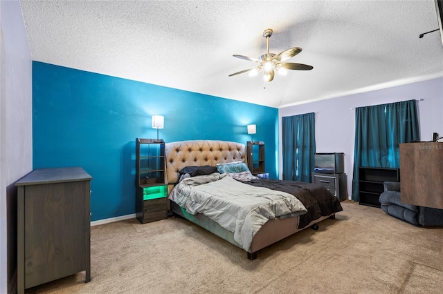 carpeted bedroom featuring lofted ceiling, ceiling fan, and a textured ceiling