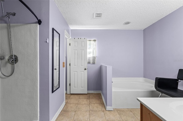 bathroom featuring tile patterned floors, vanity, independent shower and bath, and a textured ceiling