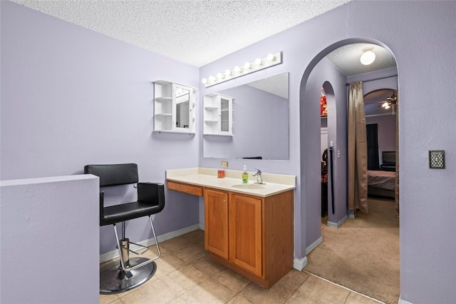 bathroom featuring vanity, a textured ceiling, and ceiling fan