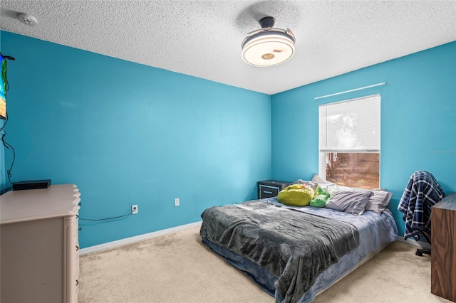 bedroom featuring a textured ceiling and light colored carpet